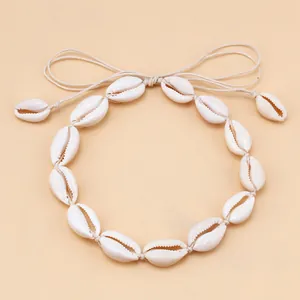 Detail of adjustable woven cotton cord and small shell accents on a beach choker necklace