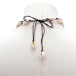 Detail of adjustable handmade shell necklace with bohemian knot tie and shell accents