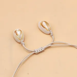 Detail of handmade woven shell necklace with natural cowrie shells and adjustable slider knot