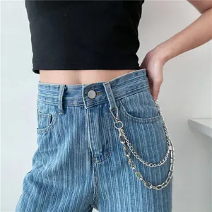 Double-layered silver metal waist chain accessory on blue striped high-waisted jeans