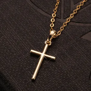 Classic gold cross pendant necklace with starburst detail on a fine golden link chain
