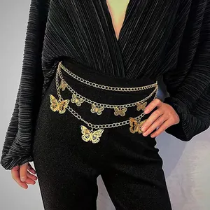 Layered gold metal waist chain with hollow butterfly pendants on a black outfit