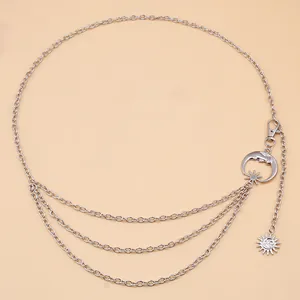 Detail of silver layered waist chain with celestial sun and moon charm pendants