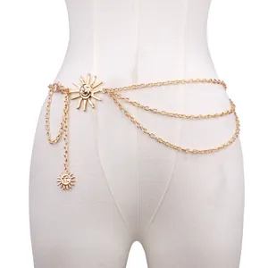 Detail of layered gold metal waist chain featuring sun charms on a white model torso
