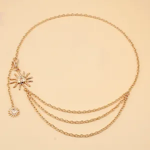Detail of gold layered waist chain featuring a sun pendant and adjustable lobster clasp