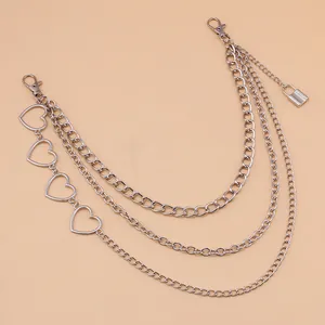 Close-up of triple-layered silver pants chain with hollow hearts and lock pendant detail