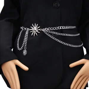 Detail of silver triple-layered metal waist chain featuring sun face pendant and lobster clasp