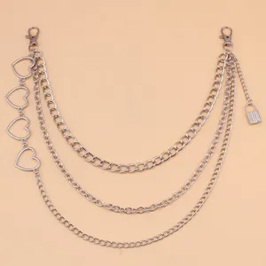 Detail of silver layered waist chain featuring hollow hearts and a mini lock charm