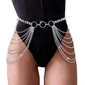 Multilayer silver body chain with rhinestones and tassel drape over black bodysuit