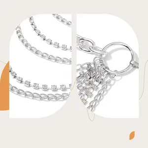 Detailed macro view of layered silver metal body chain with sparkling rhinestones