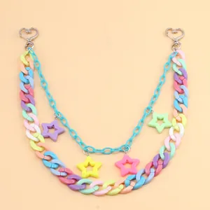 Close-up of double-layered multi-color acrylic star pendants with heart metal clasps