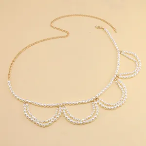 Detail of elegant gold alloy waist chain with white pearls and adjustable lobster clasp