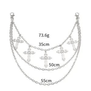 Detail of silver multilayer waist chain with engraved cross pendants and lobster clasps