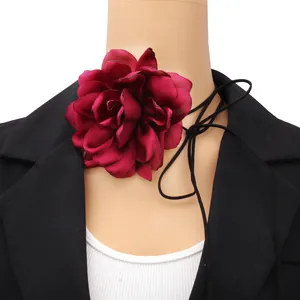 Detail of burgundy oversized 3D fabric flower choker with long black ribbon straps