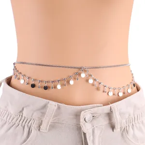 Dettaglio della catena in vita argento a doppio strato con paillettes e strass su denim
