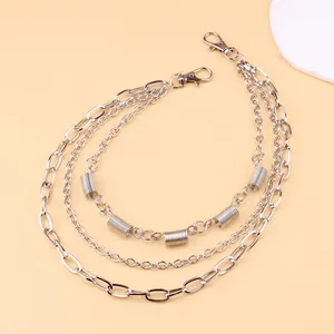 Close-up of triple-layered silver punk metal waist chains with spring accents and lobster clasps
