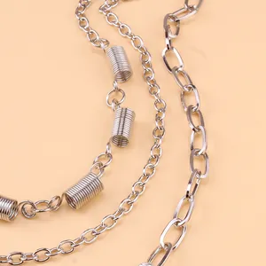 Detail of silver multi-layered chain with spring pendants and punk hip-hop style metal links