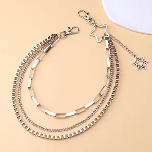 Close-up of triple-layered silver metal pant chain with star pendants and lobster clasps