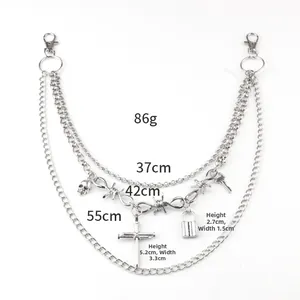 Detail view of multi-layer hip hop chain with cross and skull charms for pants