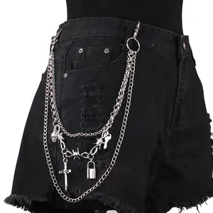 Multilayer silver punk waist chain with cross and skull charms on black denim