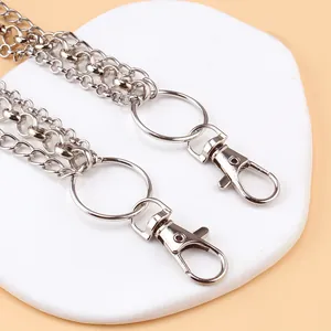 Detail of double-layer silver punk waist chain with lobster clasp and cross pendant