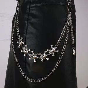 Detail of silver skull trouser chain featuring multi-layered punk metal chains and charms