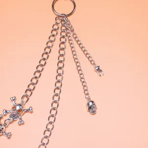 Punk silver multi-layer trouser chain with metallic skull charms and a tooth pendant