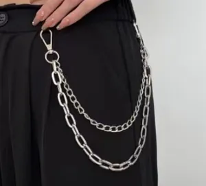 Detail of silver double-layered metal trouser chain with lobster clasps on black pants