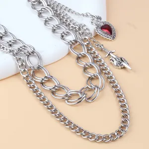 Close-up of gothic silver multi-layer pant chain with red heart and sword pendants