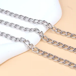 Macro detail of silver curb link body chain showing smooth metal finish and texture