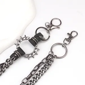 Detail of punk metal waist chain with spikes, lobster clasp, and dark gunmetal finish