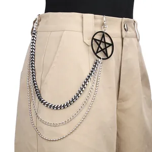 Detailed view of triple-layered metal pant chain with star pendant and silver lobster clasps