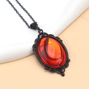 Macro view of Gothic red crystal pendant with intricate black filigree metalwork detail