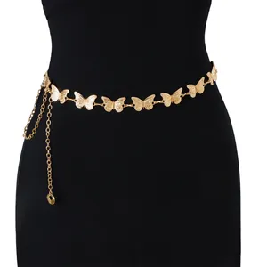 Close-up of golden butterfly waist chain with tassel and adjustable hook on black clothing