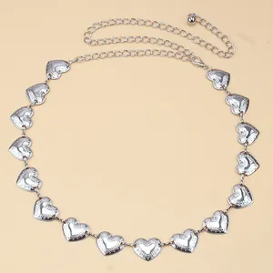 Detail of silver heart-shaped embossed metal belt with adjustable lobster clasp chain