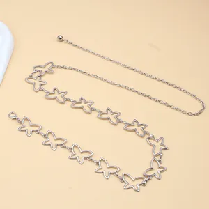 Detailed view of silver hollow butterfly links on a metal waist chain with lobster clasp