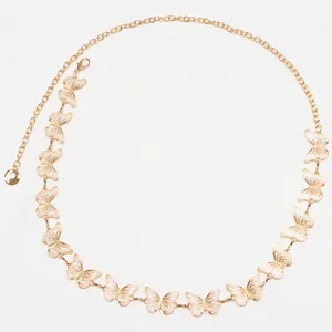 Detailed macro shot of golden hollow butterfly waist chain with lobster clasp and link texture