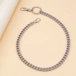 Detail of silver Cuban link pant chain with cross pendant and spring lobster clasps