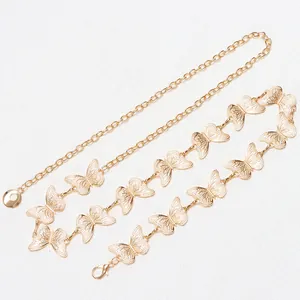 Detail of gold butterfly chain belt featuring intricate hollow wings and adjustable clasp