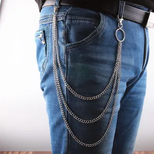 Multi-layer silver metal chain belt with punk style and lobster clasps on blue jeans