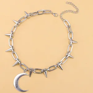 Detalle del collar punk plateado con púas de cono y gran colgante de luna creciente