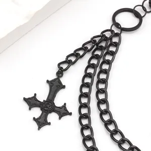 Detail of gothic multi-layer matte black metal chain with hollow cross pendant