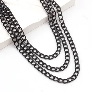 Close-up of heavy multi-layered matte black thick curb chain links for punk hip-hop fashion