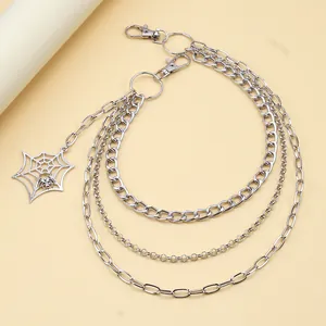 Detail of silver multi-layer metal trousers chain with gothic spider web pendant charm