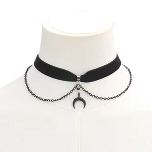 Detailed view of punk velvet choker with black moon pendant on white mannequin