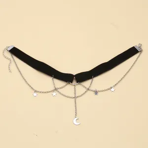 Dettaglio del choker gotico in velluto nero con pendente a luna e catenine con stelle