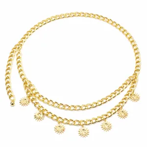 Detailed macro view of gold metal sunflower charms on a layered hip-hop style body waist chain