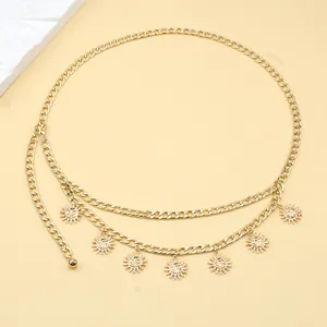 Detailed close-up of golden metal waist chain featuring sun pendants with facial relief