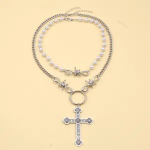 Close-up of double-layer punk necklace featuring gothic cross pendant and pearls
