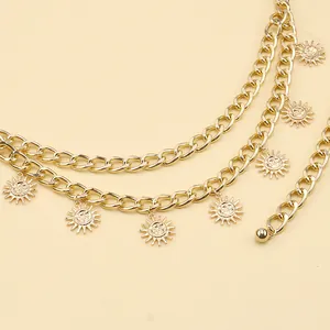 Detail of a vintage gold double-layer body chain with hanging sun face pendants